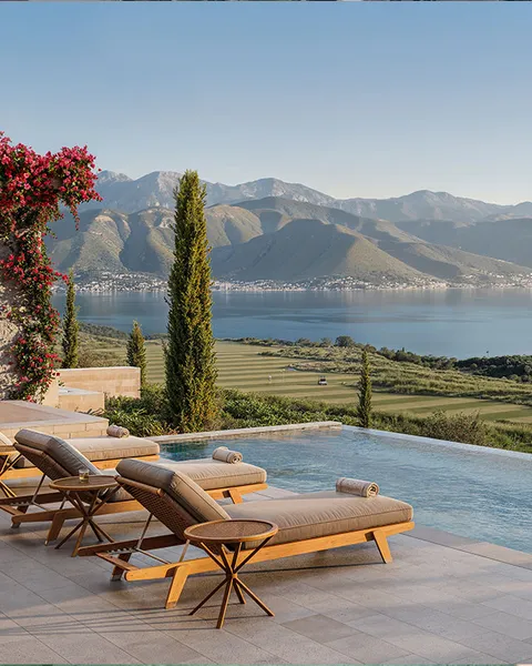 Luxury villa pool area with sunbeds and umbrellas
